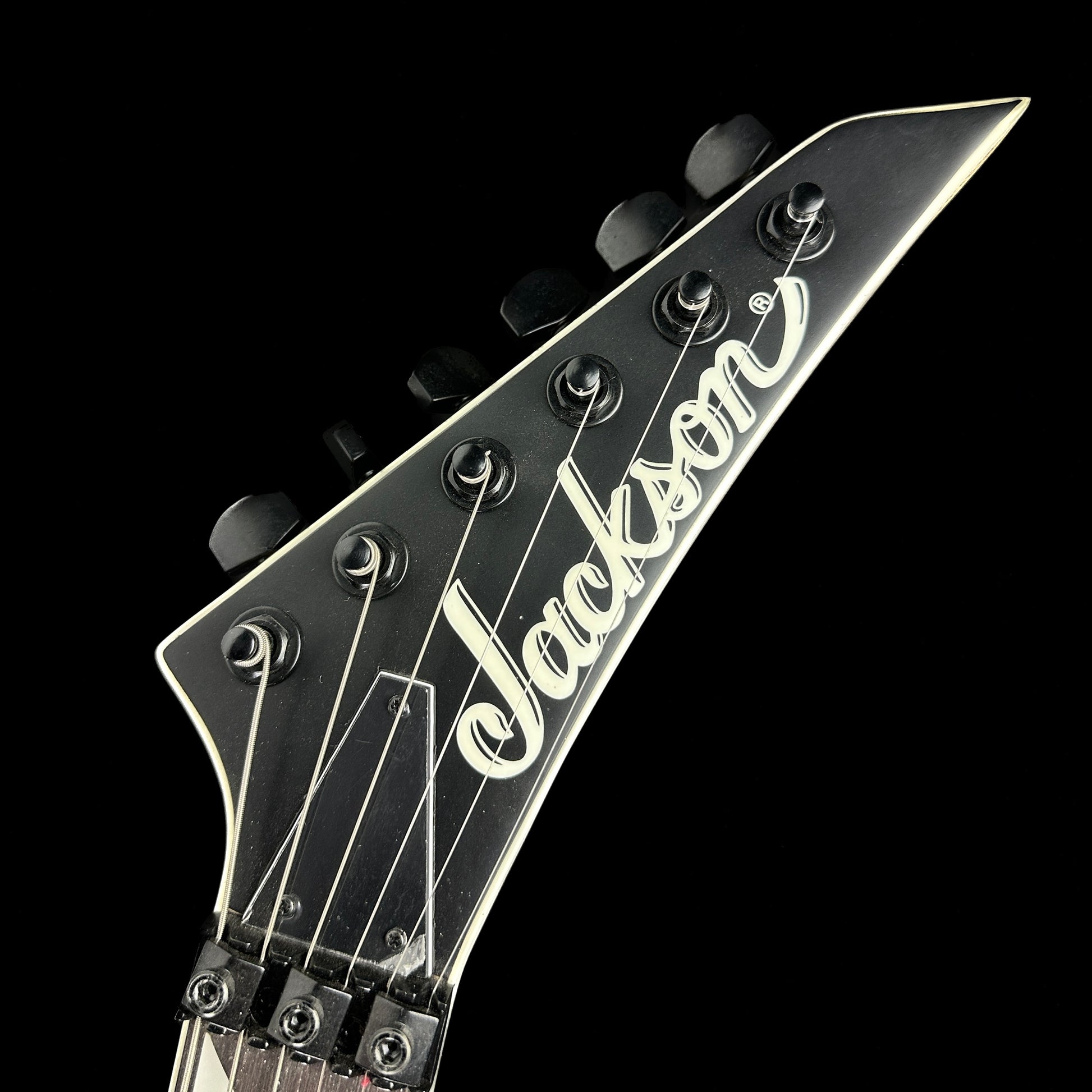 Front of headstock of Used Jackson JS32 King V Army Drab.