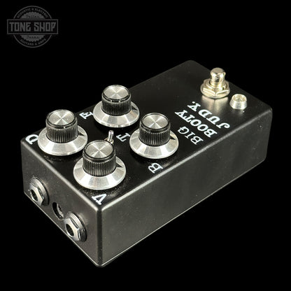 Black guitar effects pedal with silver knobs and labels on a black background, featuring 'Tone Shop' logo.