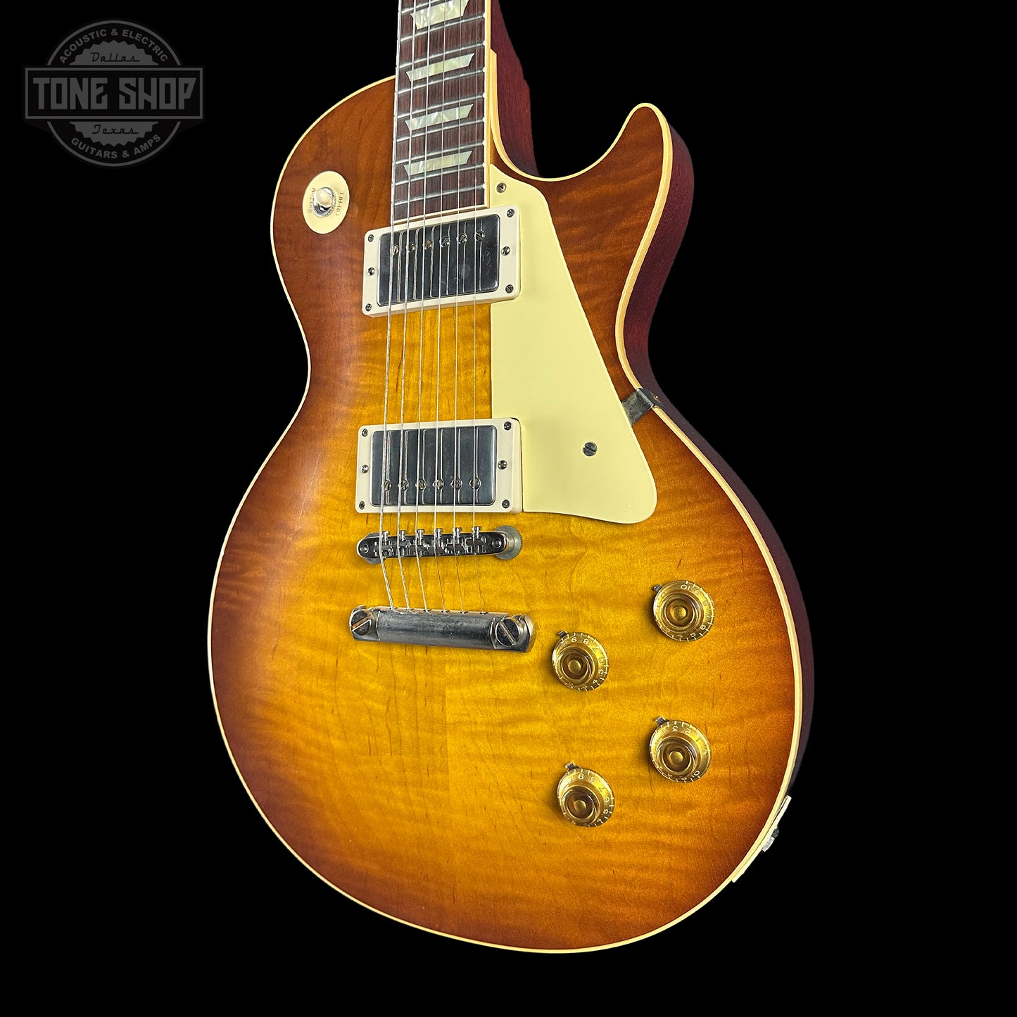 Electric guitar with a sunburst finish on a black background, featuring the Tone Shop logo.