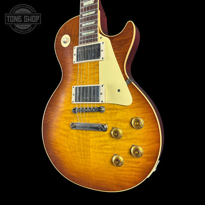 Electric guitar with a sunburst finish on a black background, featuring the Tone Shop logo.