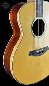 Acoustic guitar with a focus on the body and neck against a black background