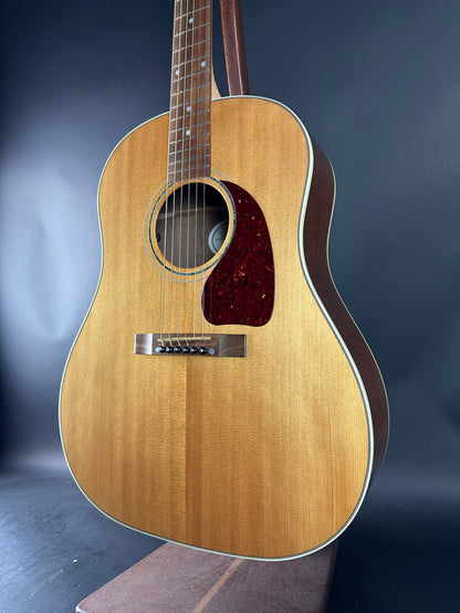Acoustic guitar with a wooden finish on a dark background