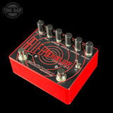 Guitar effects pedal with red and black design on a black background, featuring the brand 'Tone Shop'.