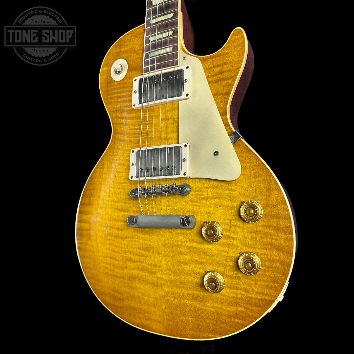 Electric guitar with a sunburst finish on a black background, featuring the Tone Shop logo.