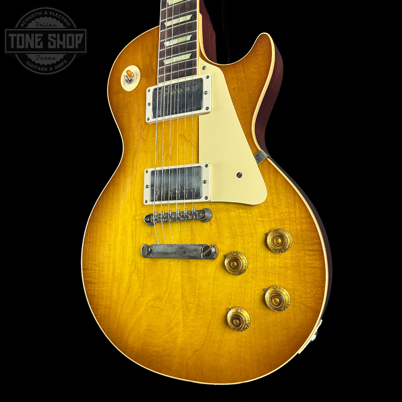 Electric guitar with a sunburst finish on a black background, featuring the Tone Shop logo.