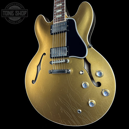 Gold electric guitar on a black background with 'Tone Shop' logo.