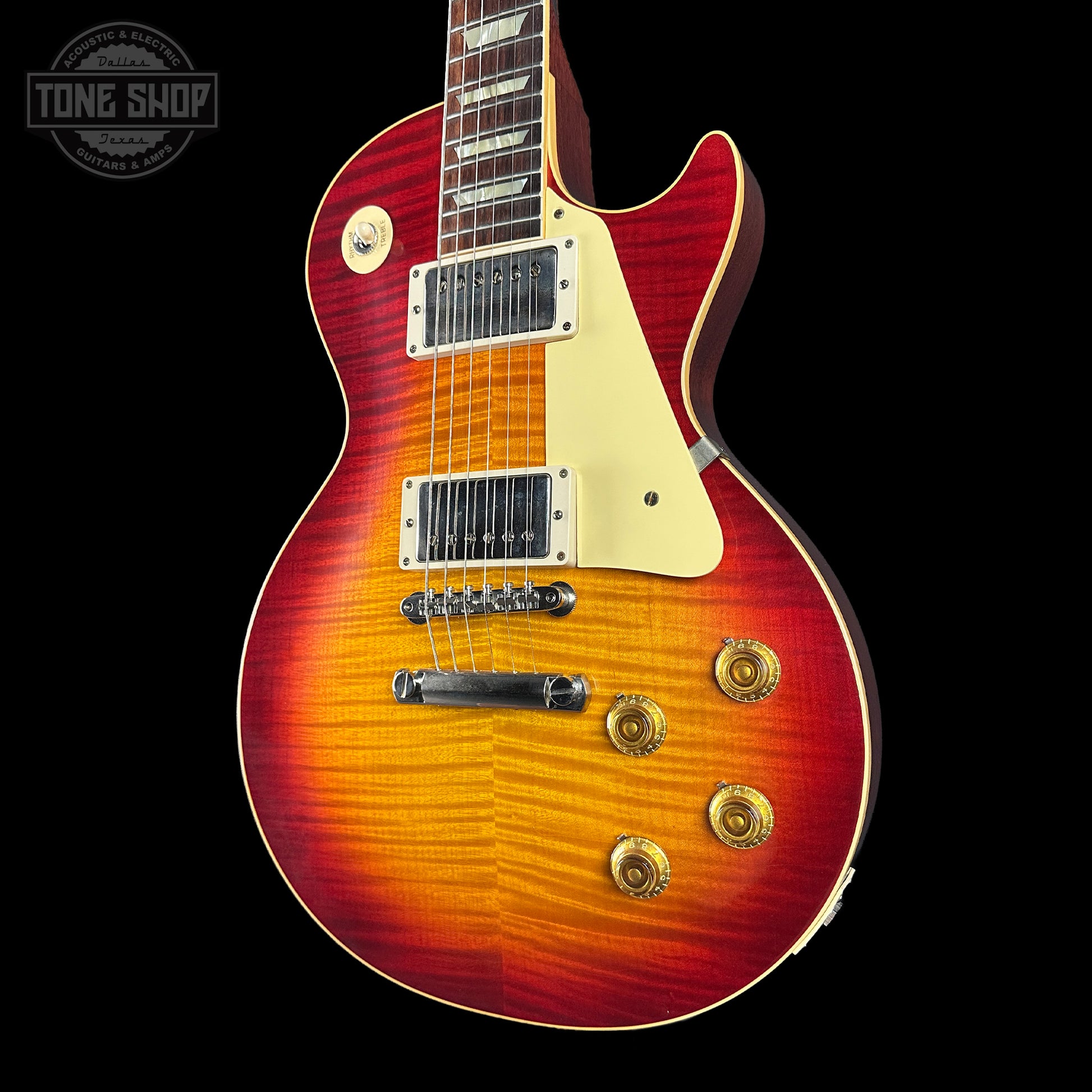 Electric guitar with a sunburst finish on a black background, featuring the Tone Shop logo.