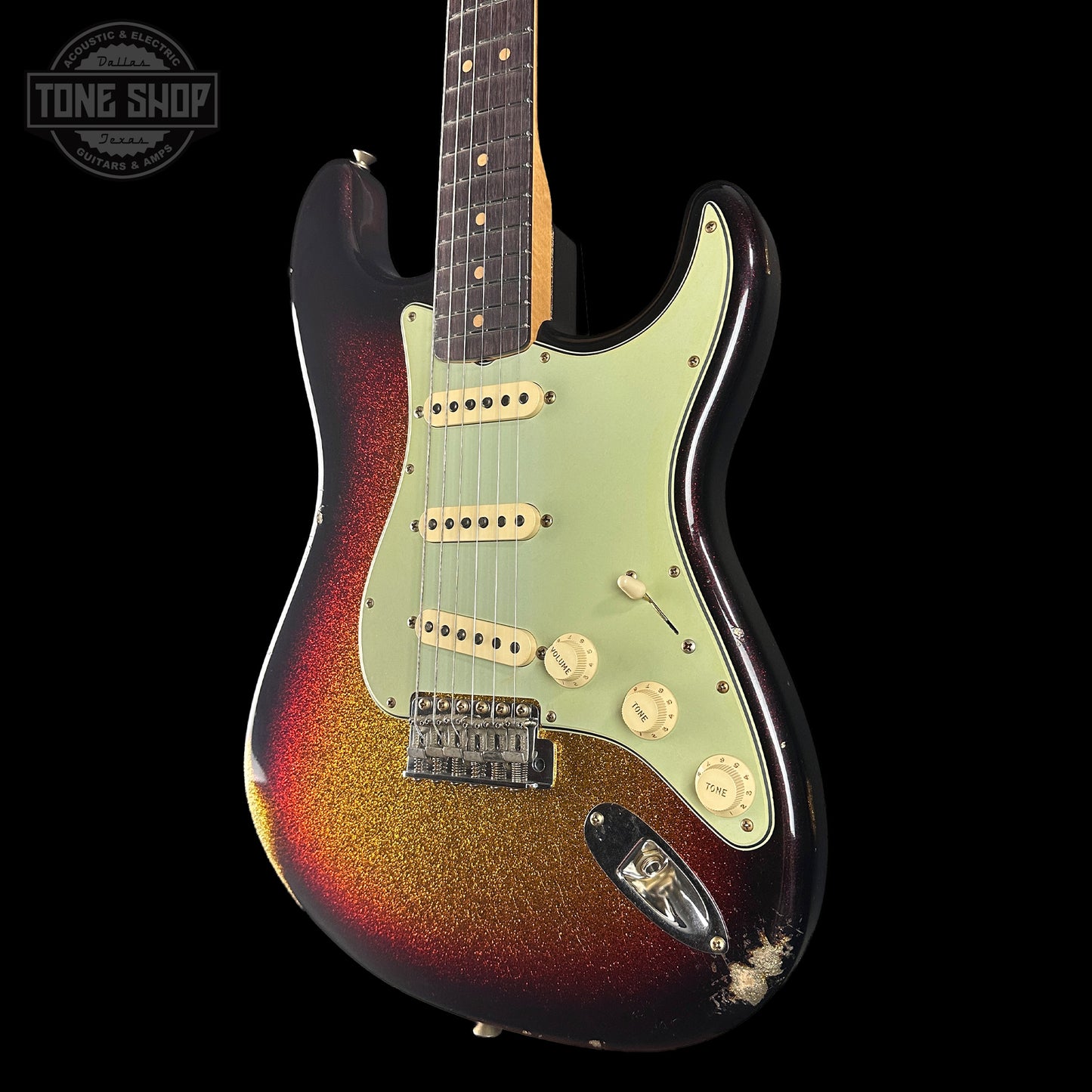 Electric guitar with sunburst finish on a black background, featuring 'Tone Shop' logo.