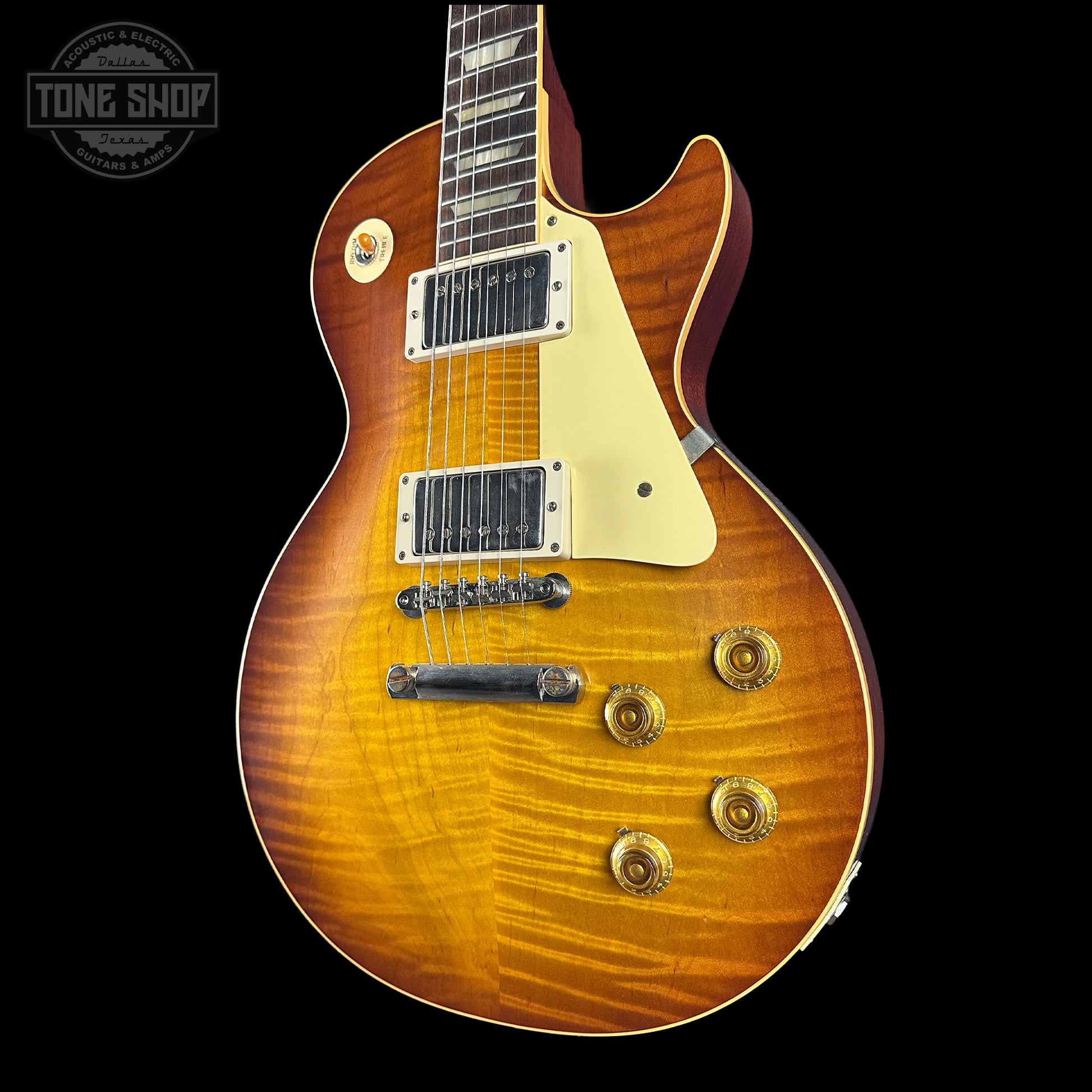 Electric guitar with a sunburst finish on a black background, featuring the Tone Shop logo.