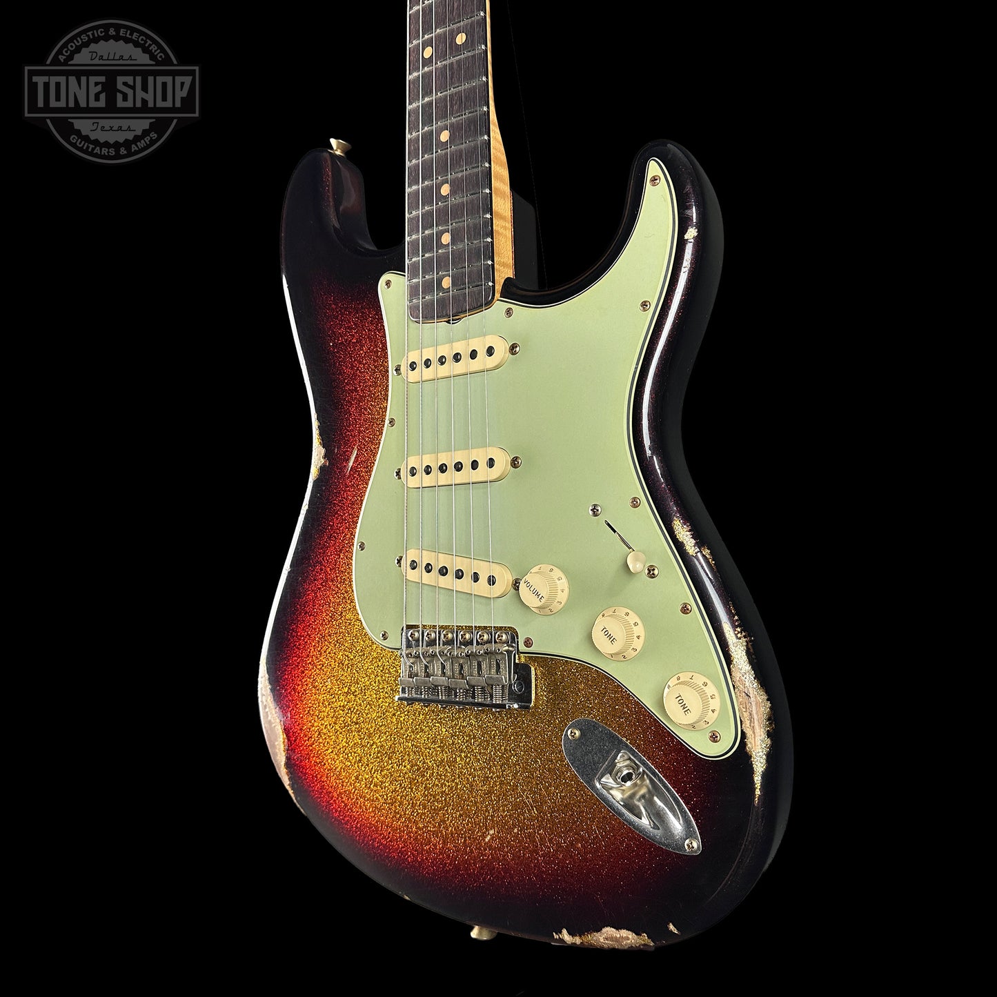 Electric guitar with a sunburst finish on a black background, featuring the Tone Shop logo.