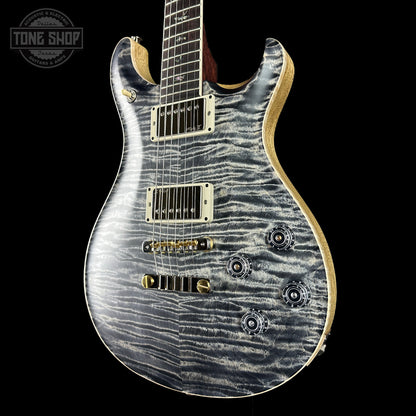 Electric guitar with a zebra pattern on a black background, featuring the Tone Shop logo.