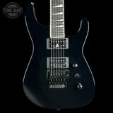Black electric guitar on a black background with 'Tone Shop' logo.