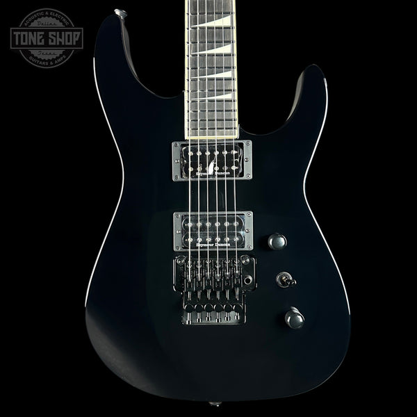 Black electric guitar on a black background with 'Tone Shop' logo.