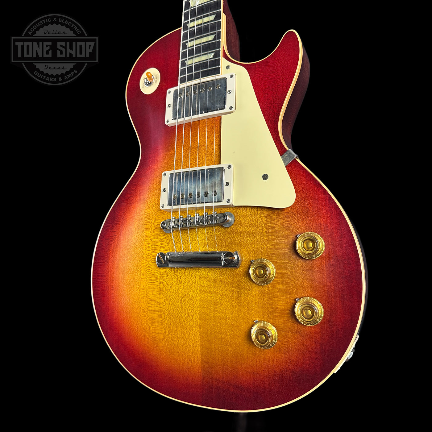 Electric guitar with a sunburst finish on a black background, featuring the Tone Shop logo.