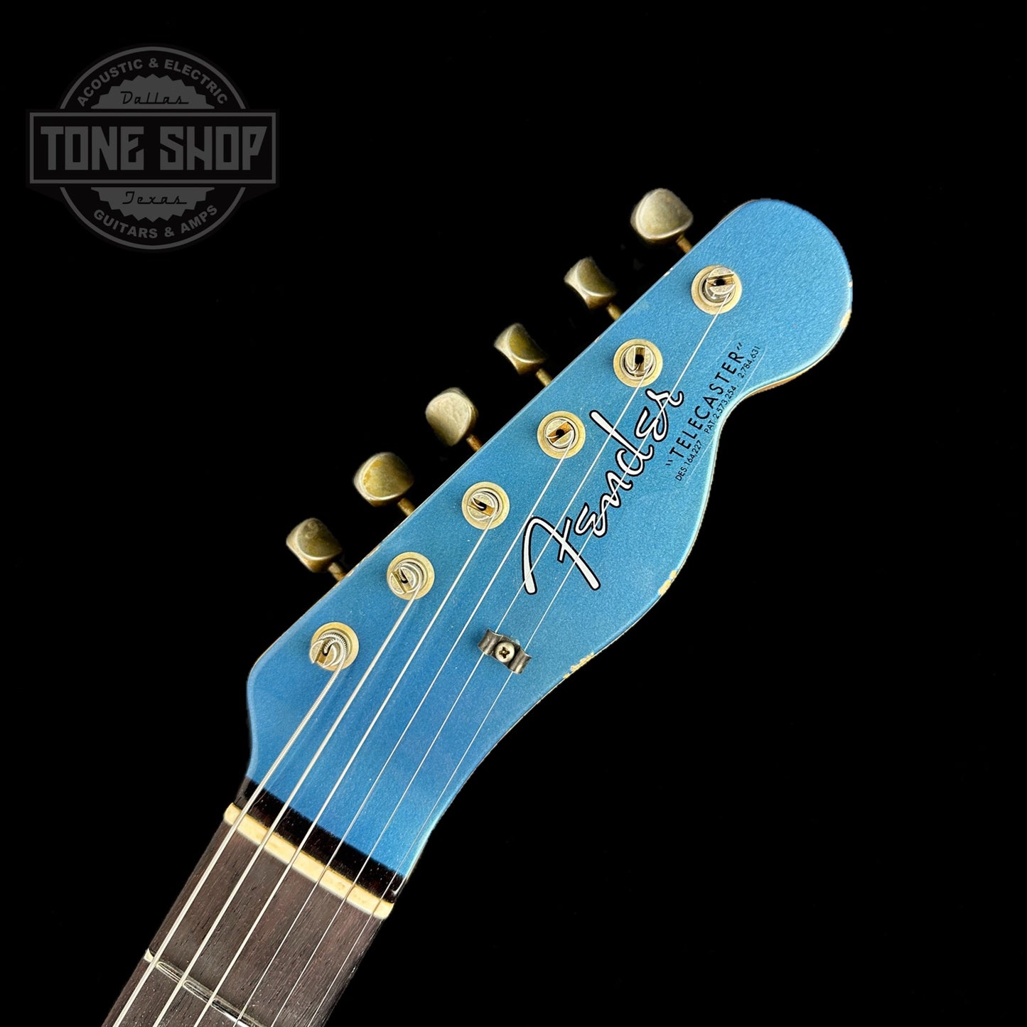 Front of headstock of Fender Custom Shop Limited Edition '64 Tele Relic Aged Lake Placid Blue.
