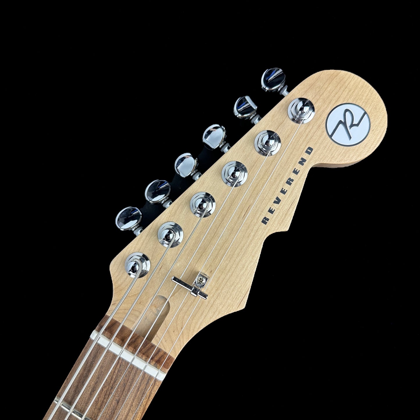 Front of headstock of Used Reverend Descent Baritone Trans White.