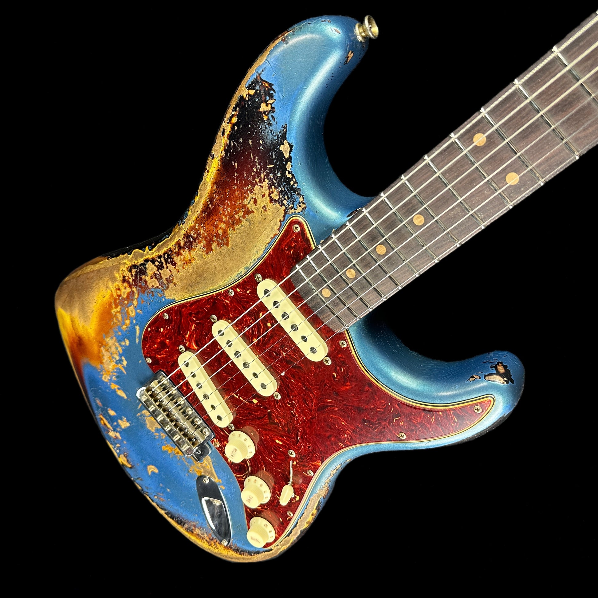 Front angle of Fender Custom Shop Limited Edition Roasted '60 Strat Super Heavy Relic Aged Lake Placid Blue Over 3 Color Sunburst.