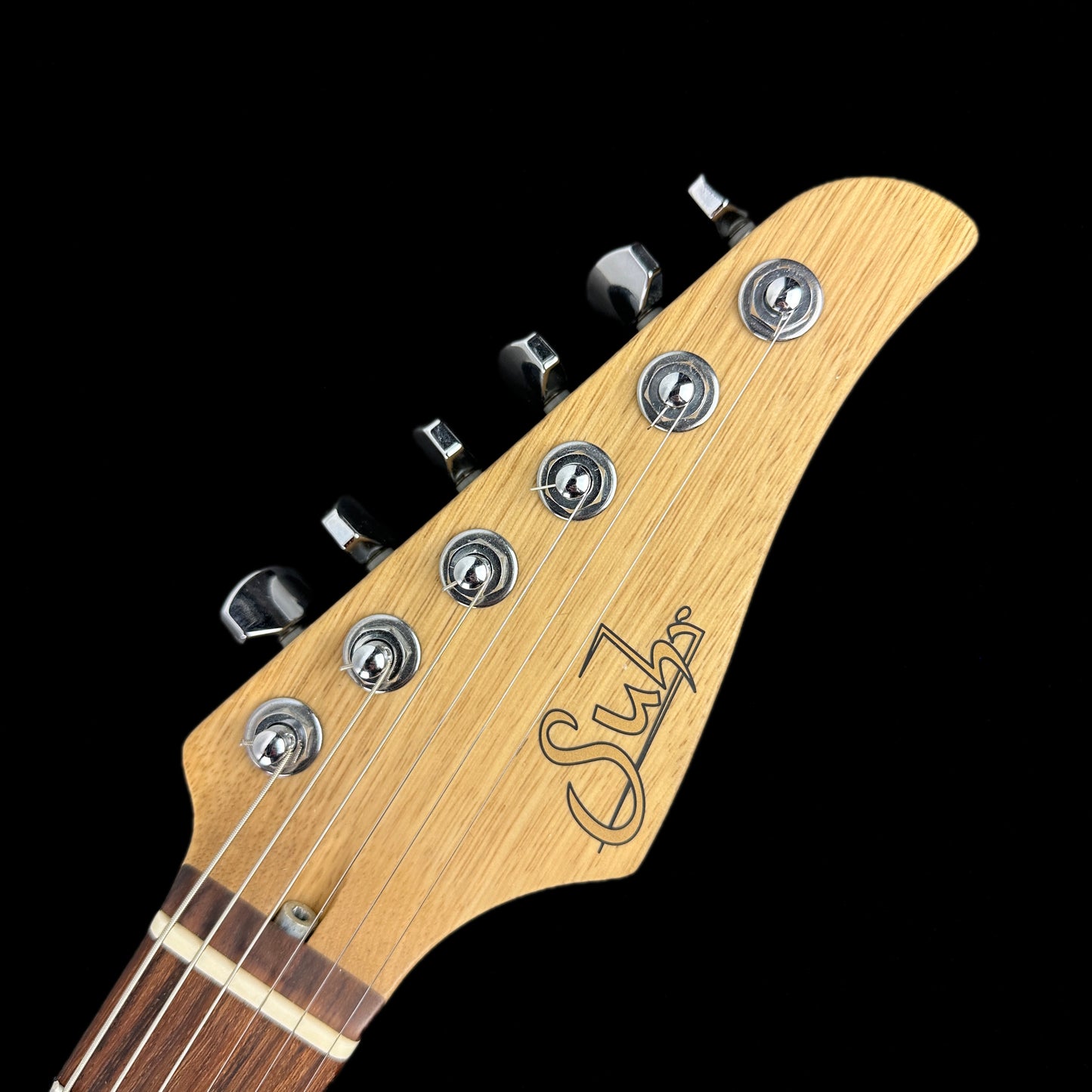 Front of headstock of Used Suhr Classic T Custom P90 Korina w/Spalted Maple Top.