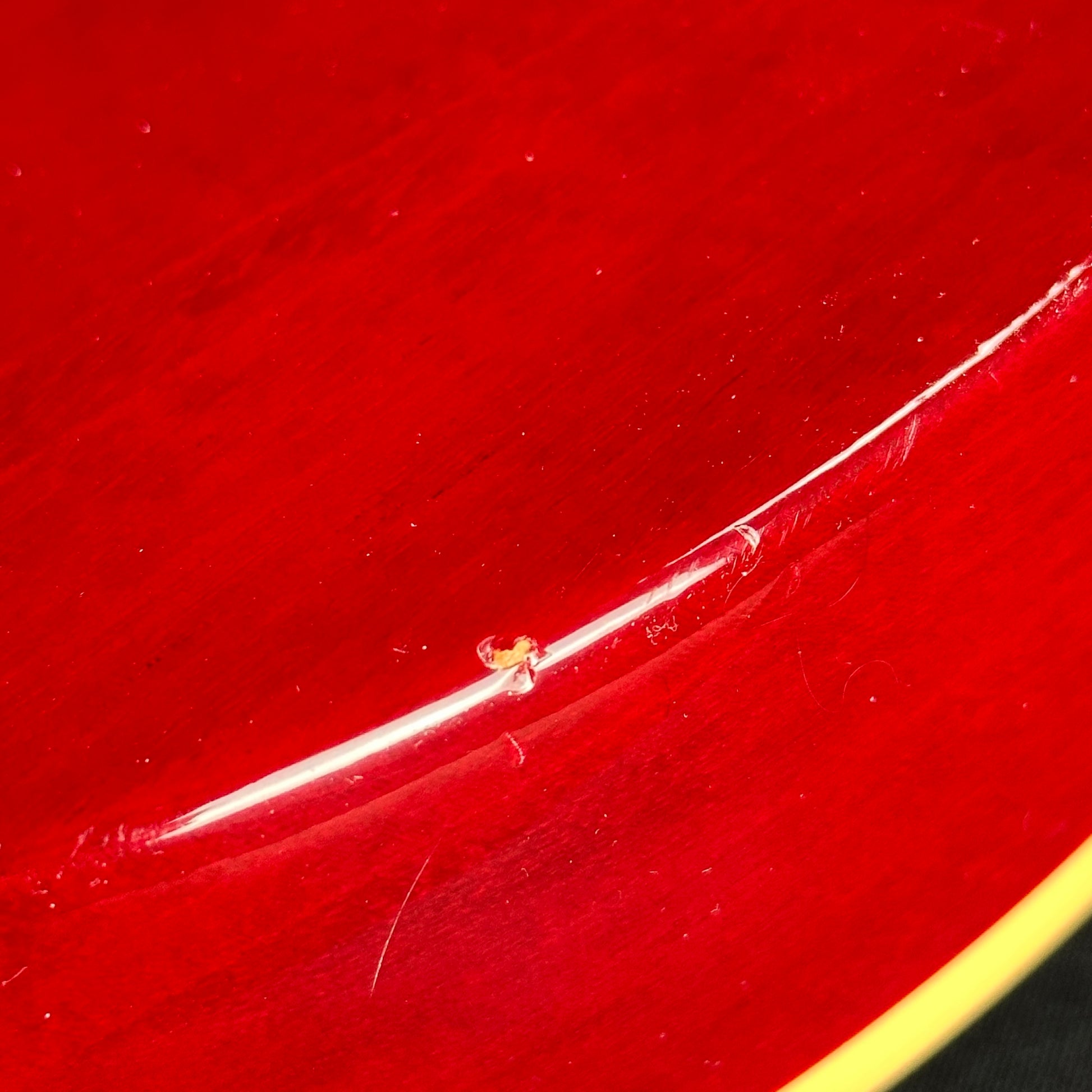 Damage on back edge of Used Gibson Les Paul Classic Cherry Burst.