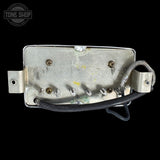 back of metal guitar pickup with visible wiring on a black background, featuring 'Tone Shop' logo.