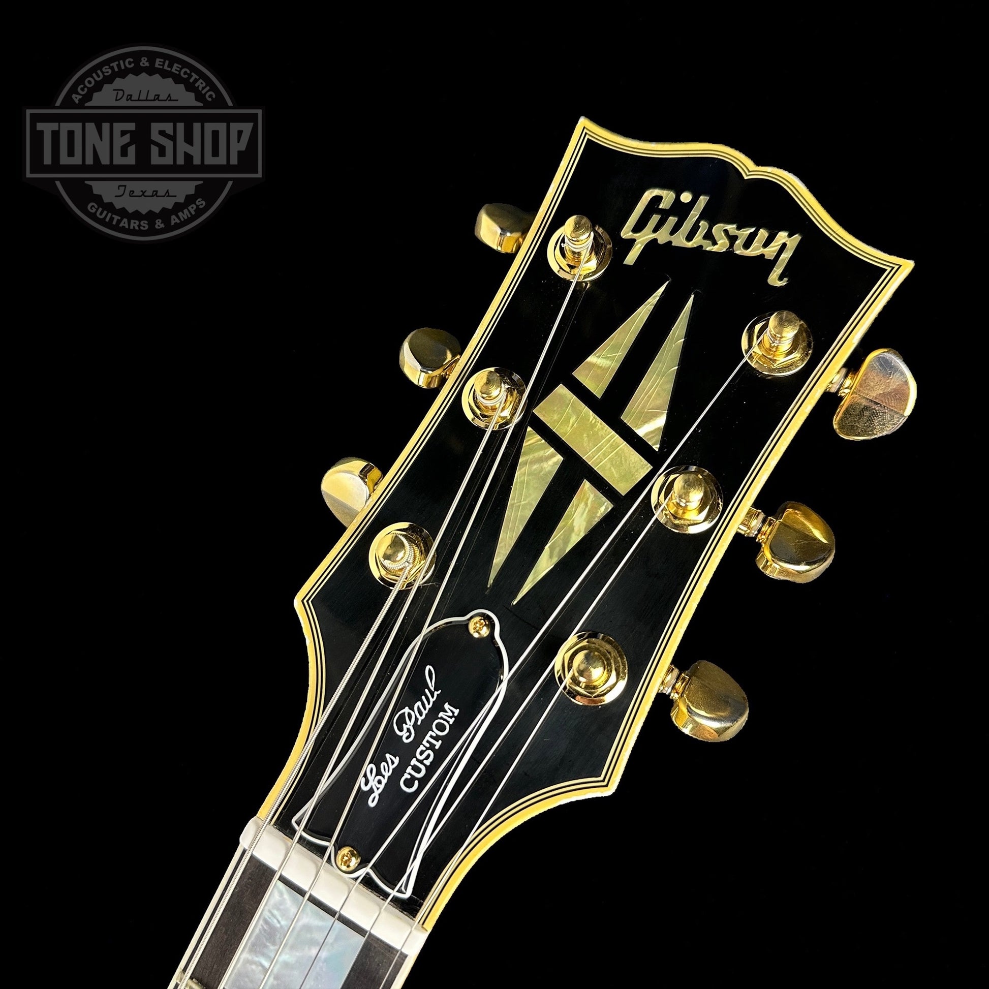 Front of headstock of on Custom Shop M2M Les Paul Custom Antique Silver Murphy Lab Light Aged GH.