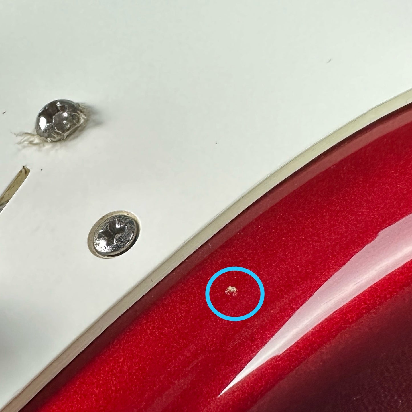 Small ding on body of Used 1983 Fender Dan Smith Era Candy Apple Strat.