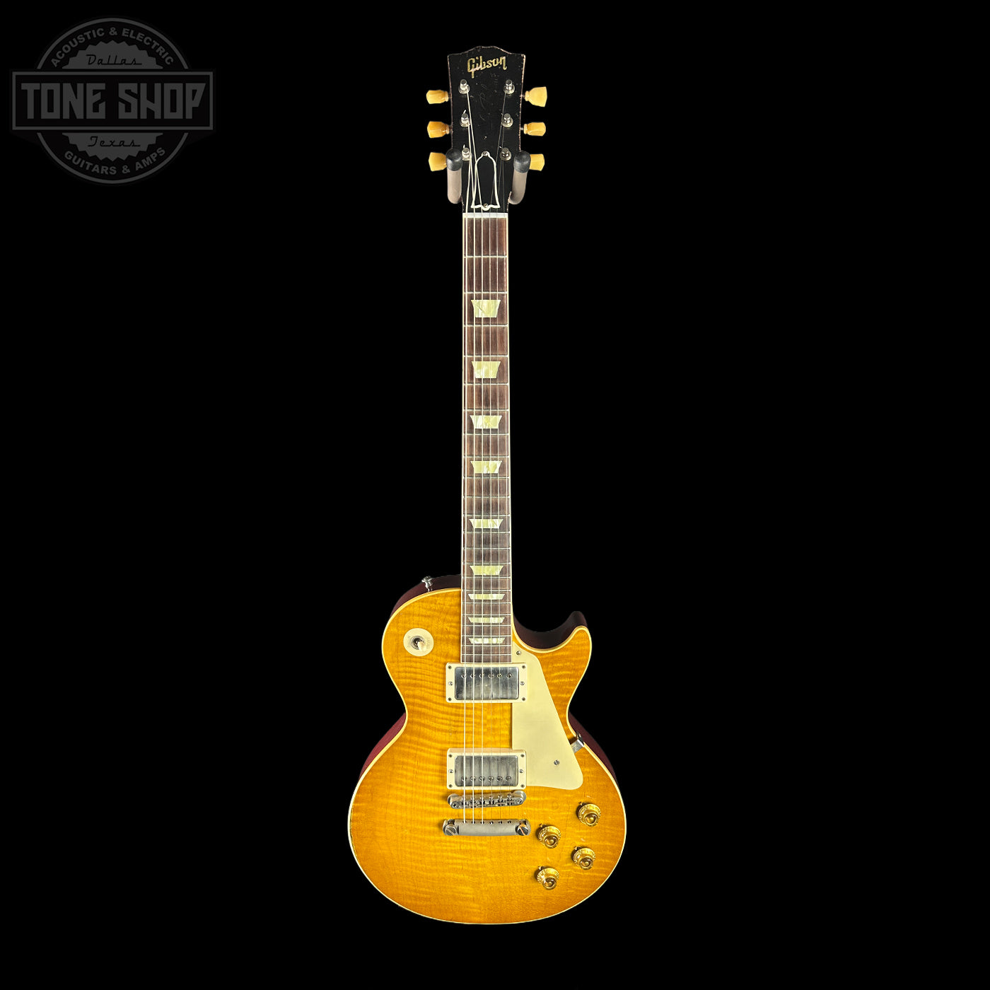 Electric guitar with a sunburst finish on a black background, featuring the Tone Shop logo.