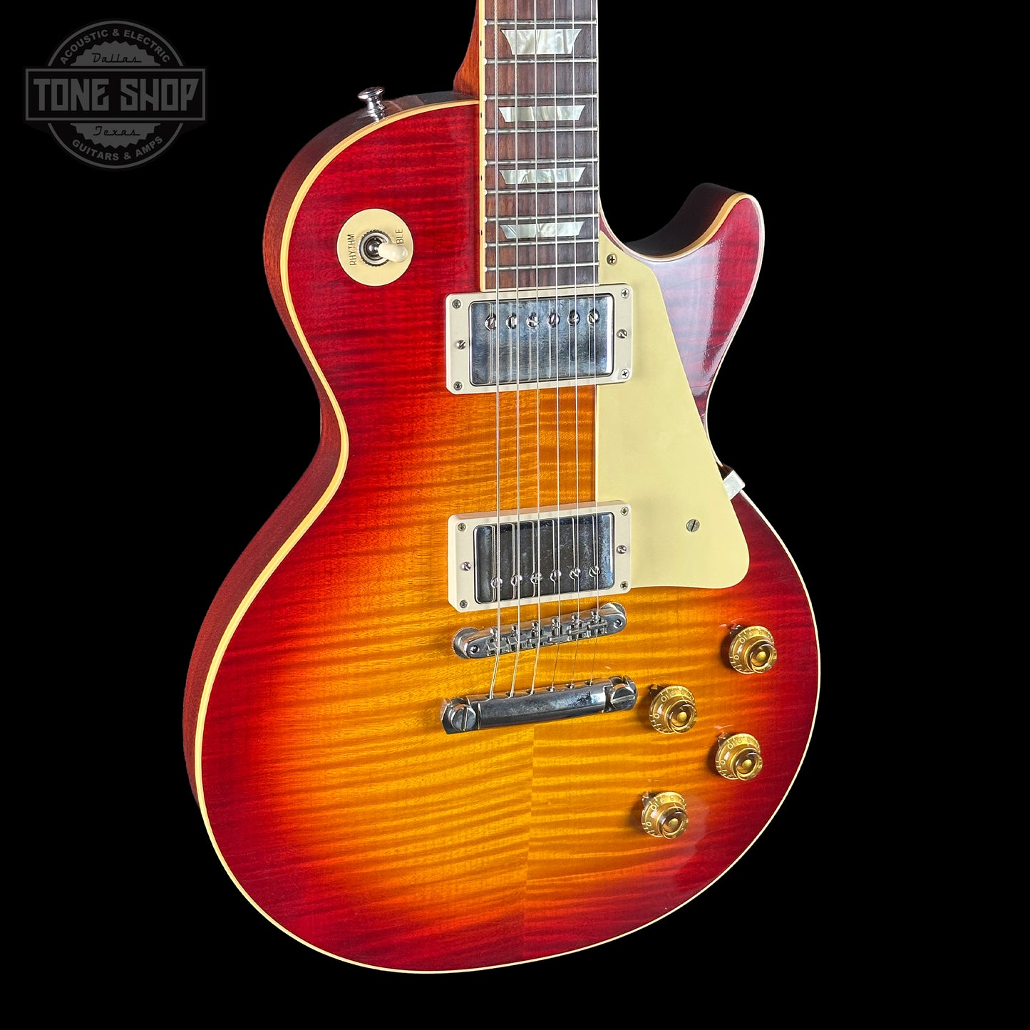 Electric guitar with a sunburst finish on a black background, featuring the Tone Shop logo.