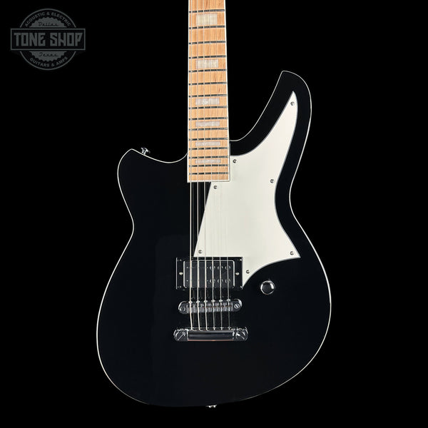 Black electric guitar with a white pickguard on a black background, featuring 'Tone Shop' branding.