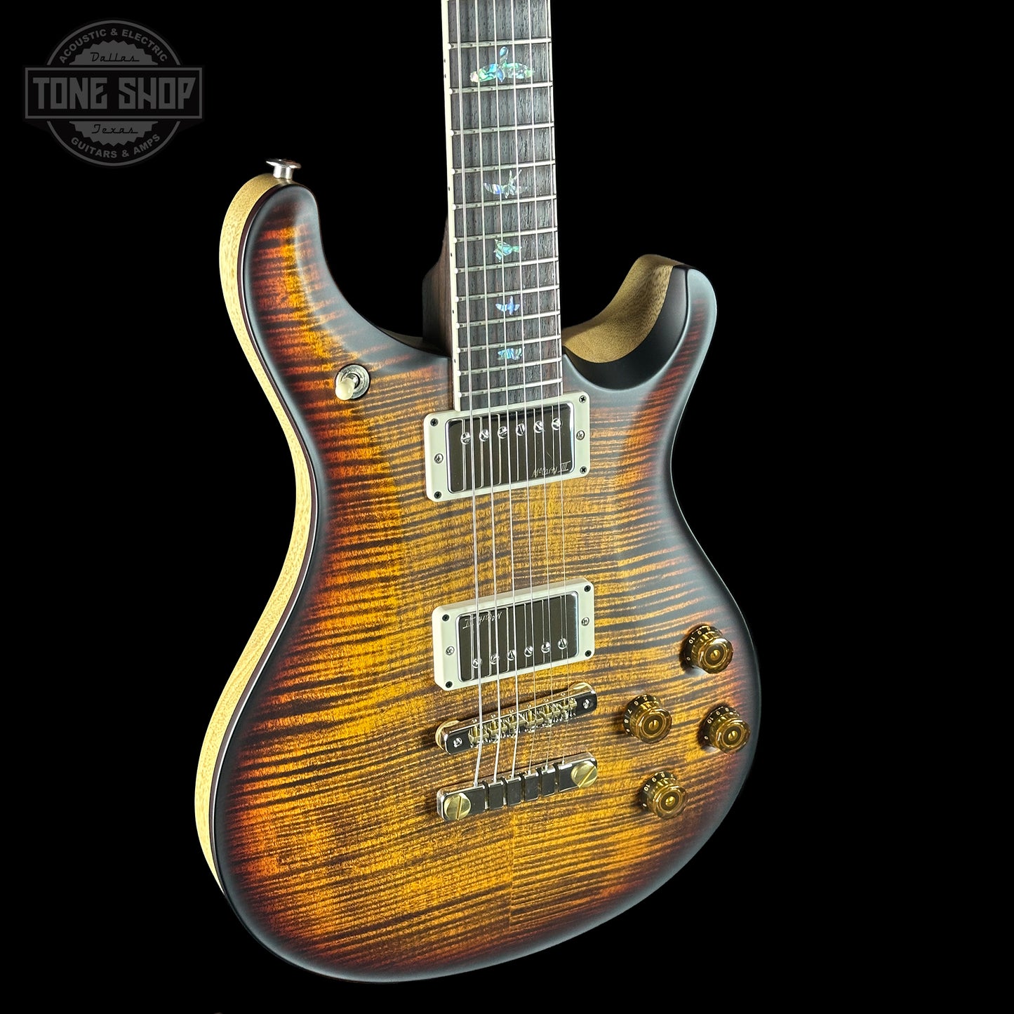 Electric guitar with a sunburst finish on a black background, featuring the Tone Shop logo.