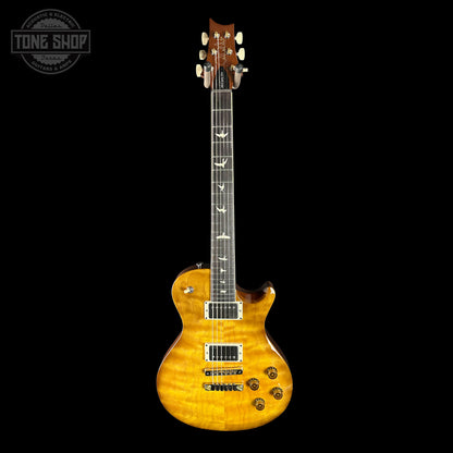 Electric guitar with a quilted maple top on a black background, featuring the Tone Shop logo.