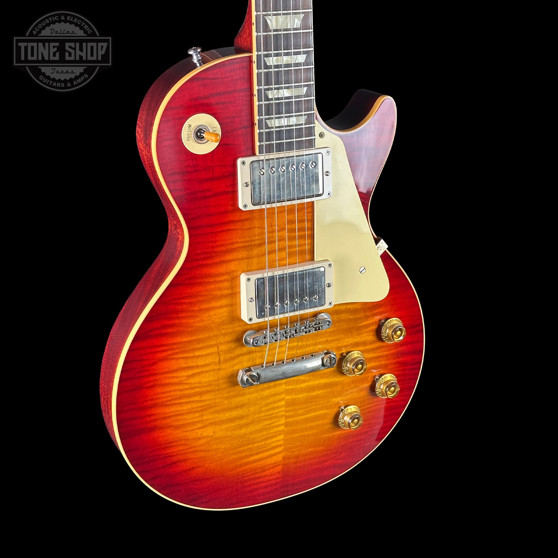 Electric guitar with a sunburst finish on a black background, featuring the Tone Shop logo.