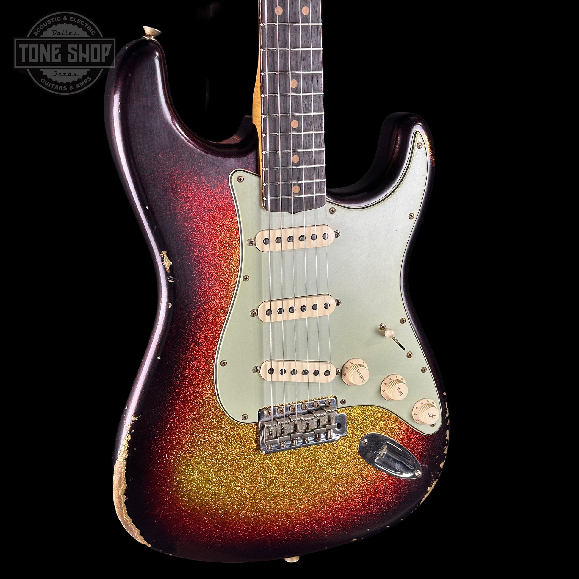 Electric guitar with a sunburst finish on a black background, featuring the Tone Shop logo.