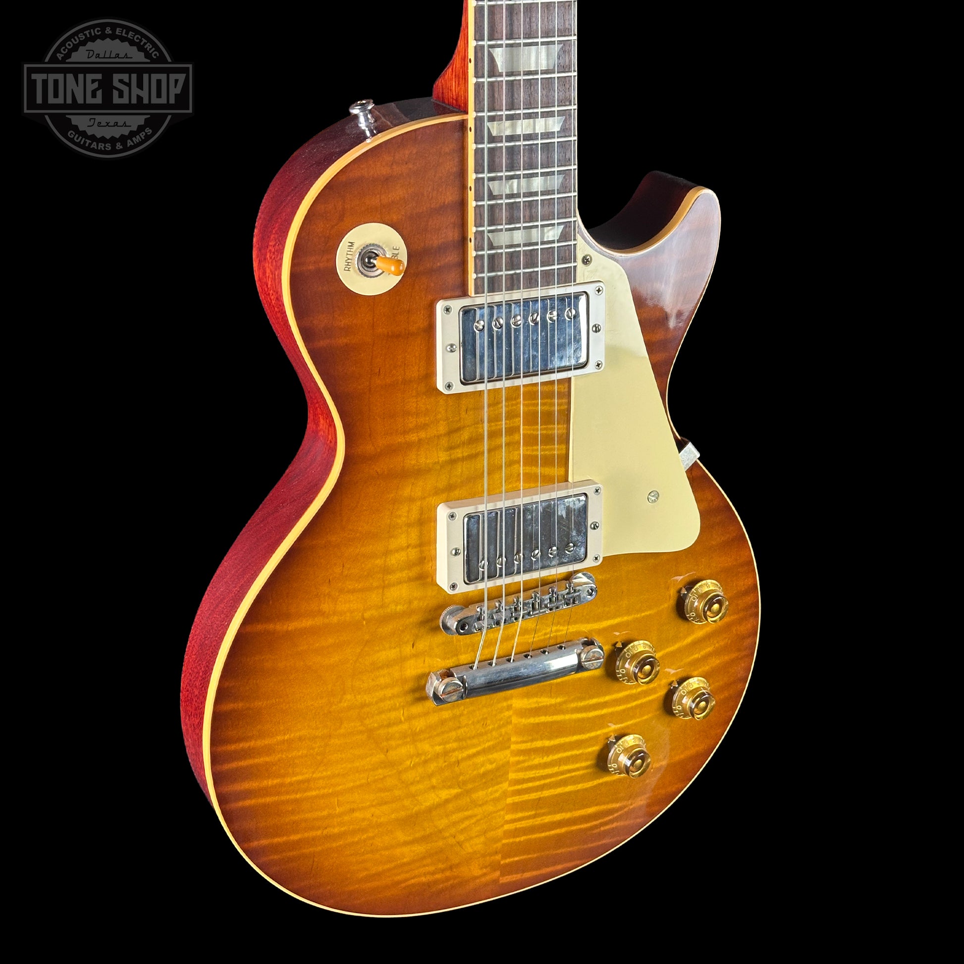 Electric guitar with a sunburst finish on a black background, featuring the Tone Shop logo.