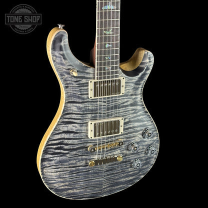 Electric guitar with a unique pattern on the body against a black background, featuring the 'Tone Shop' logo.