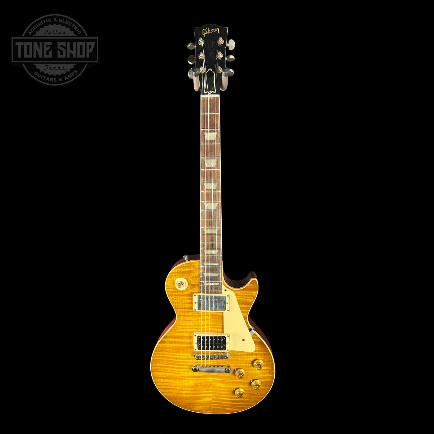 Electric guitar with a sunburst finish on a black background, featuring the Gibson logo.