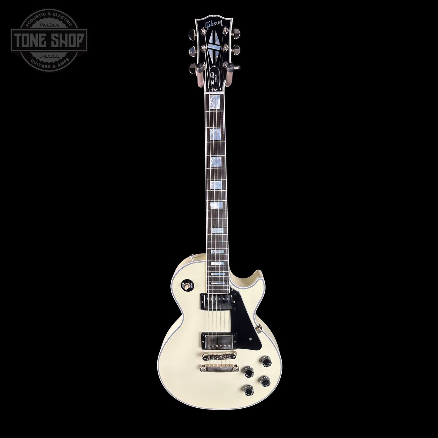 White electric guitar on a black background with 'Tone Shop' logo.