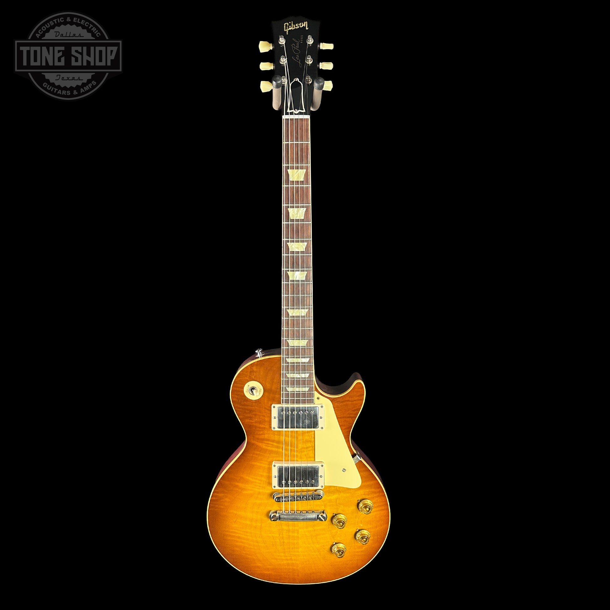 Gibson electric guitar with a sunburst finish on a black background