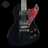 Black electric guitar with red pickguard and knobs on a black background, featuring 'Tone Shop' logo.