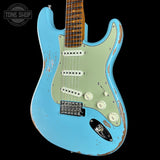 A light blue electric guitar with a distressed finish, a pale green pickguard, and a brown maple neck, shown against a black background with a Tone Shop watermark in the top left corner.