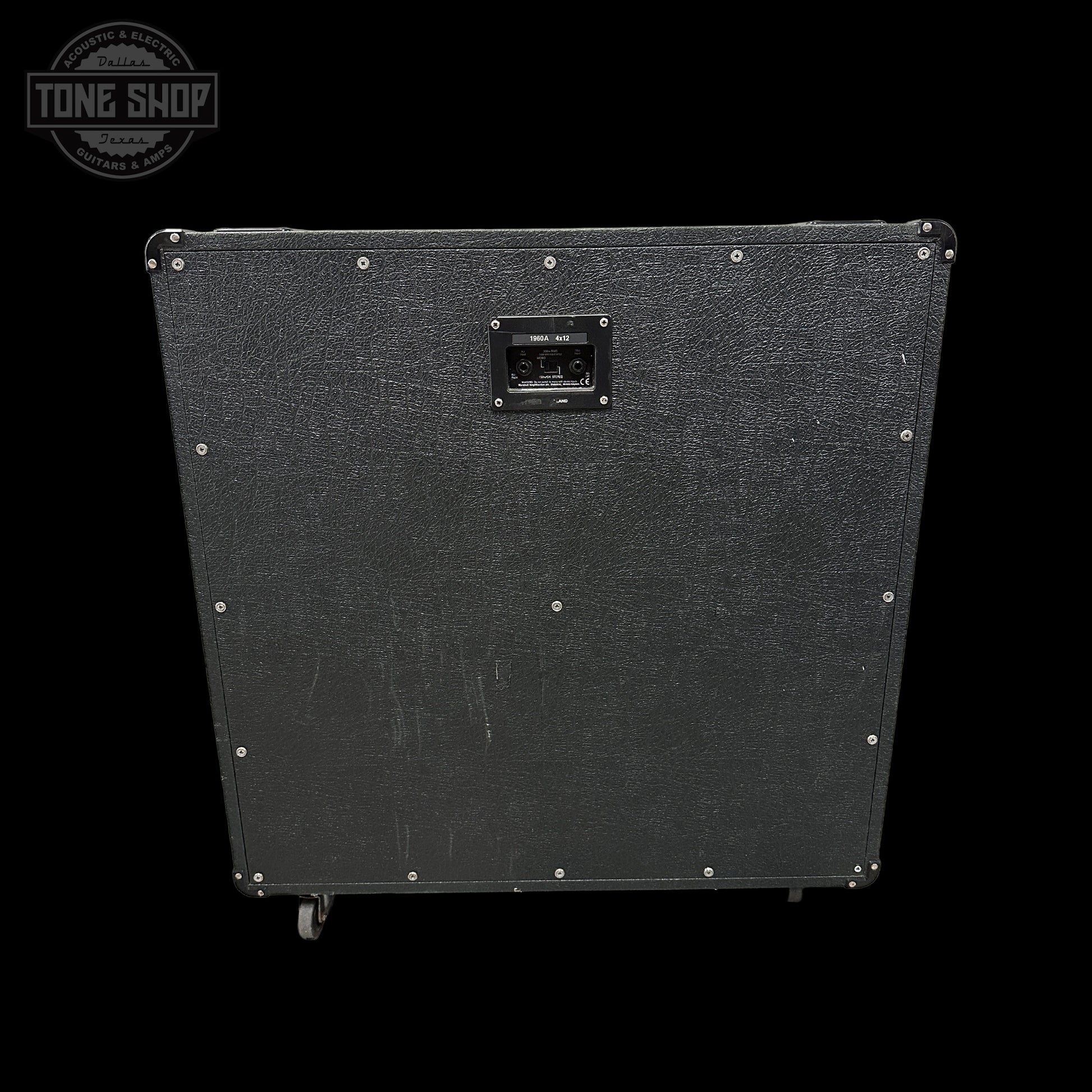Black guitar amplifier cabinet with visible brand logo on a black background
