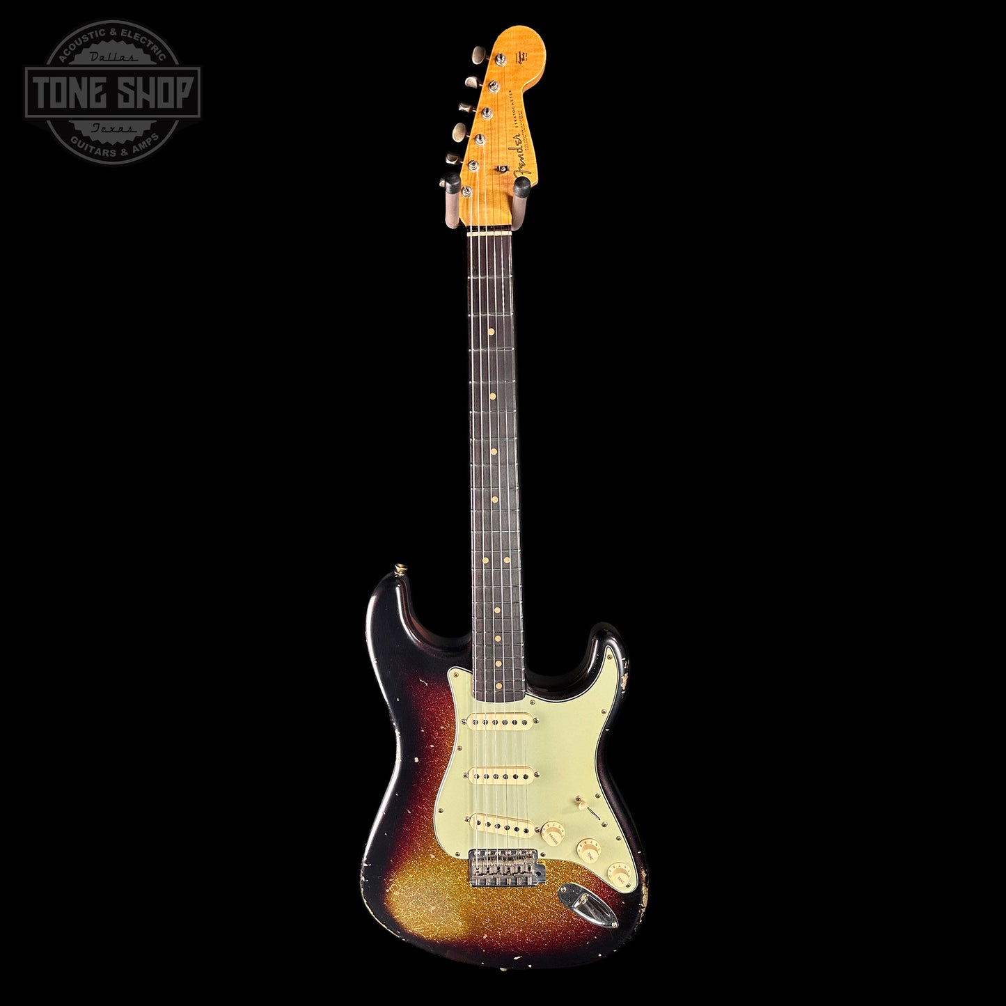 Electric guitar with a sunburst finish on a black background, featuring 'Tone Shop' logo.