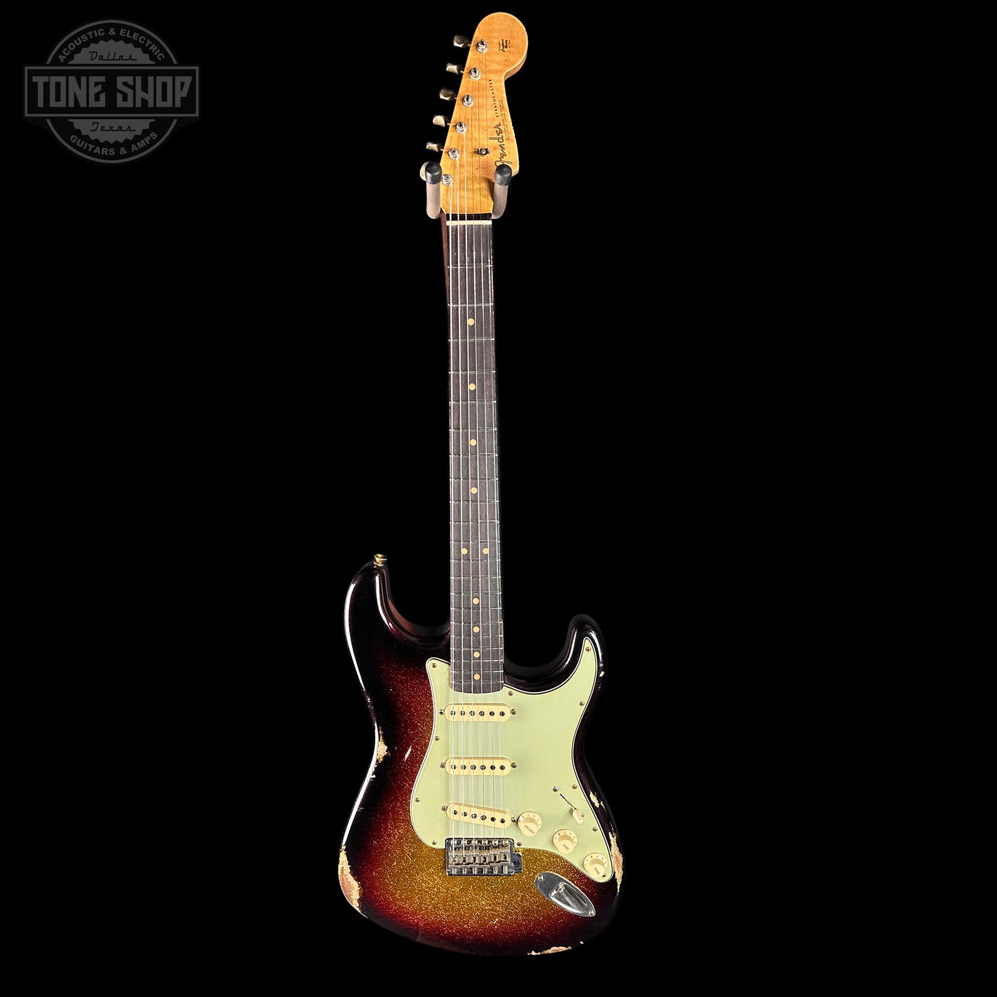 Electric guitar with a sunburst finish on a black background, featuring the Tone Shop logo.