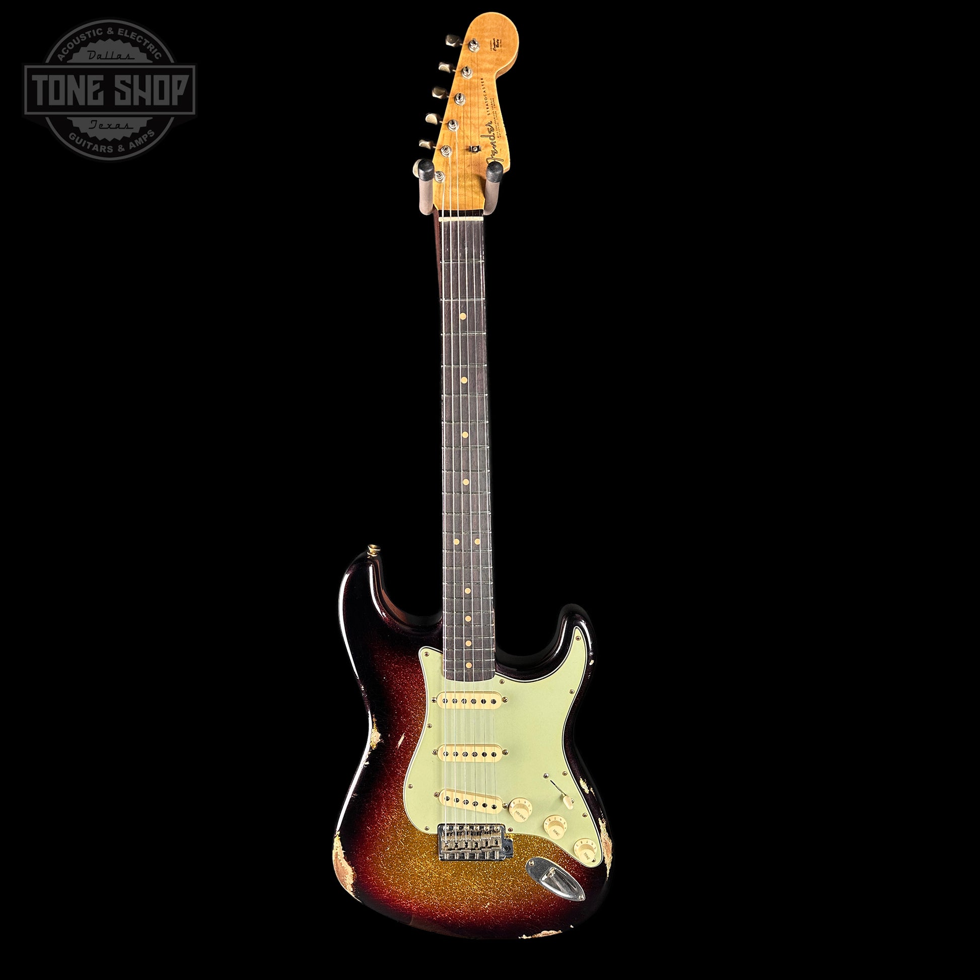 Electric guitar with a sunburst finish on a black background, featuring the Tone Shop logo.