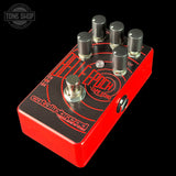 Red and black guitar effects pedal with 'Tone Shop' branding on a black background