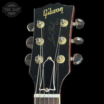 Gibson Les Paul guitar headstock with brand logo on a black background