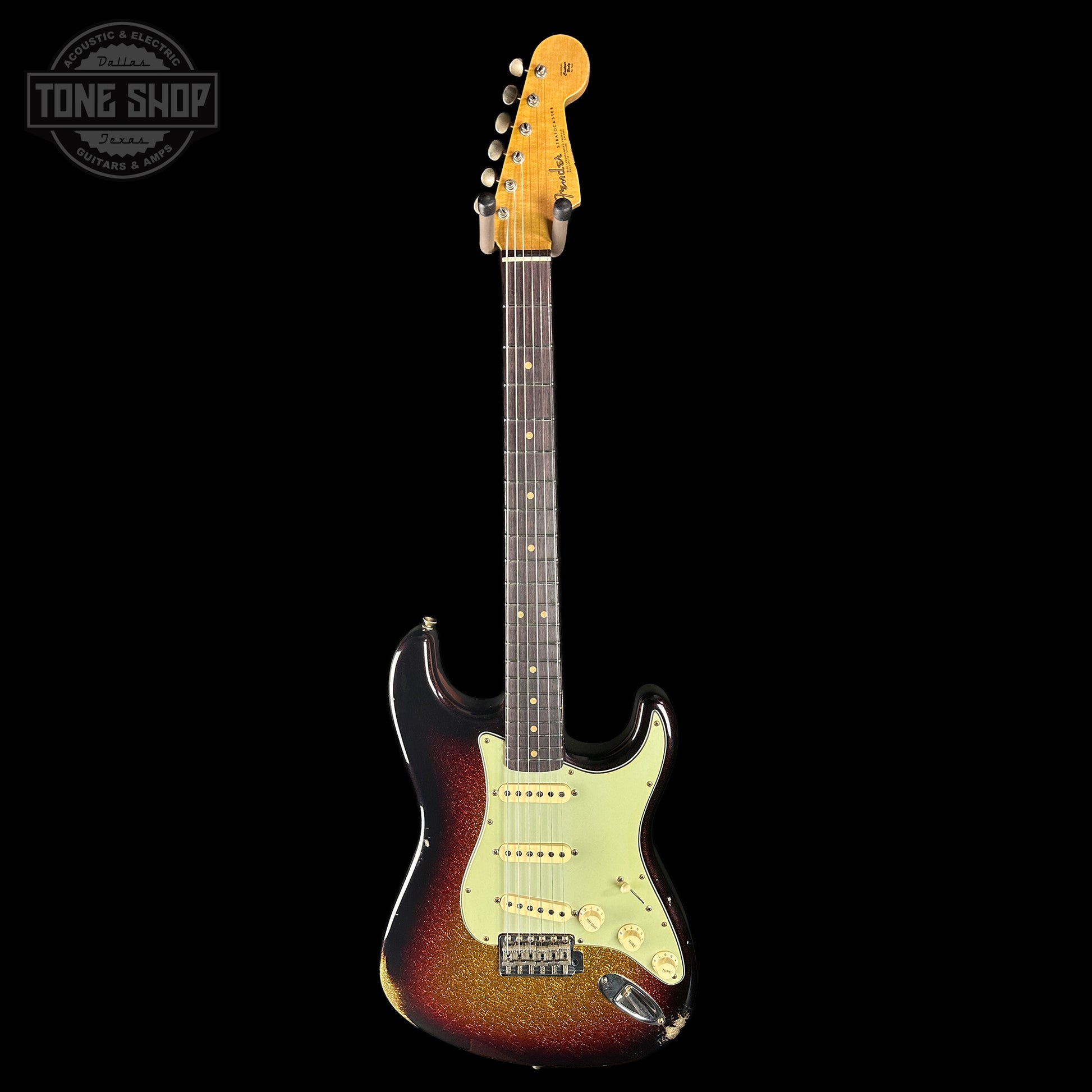 Electric guitar with a sunburst finish on a black background, featuring the Tone Shop logo.