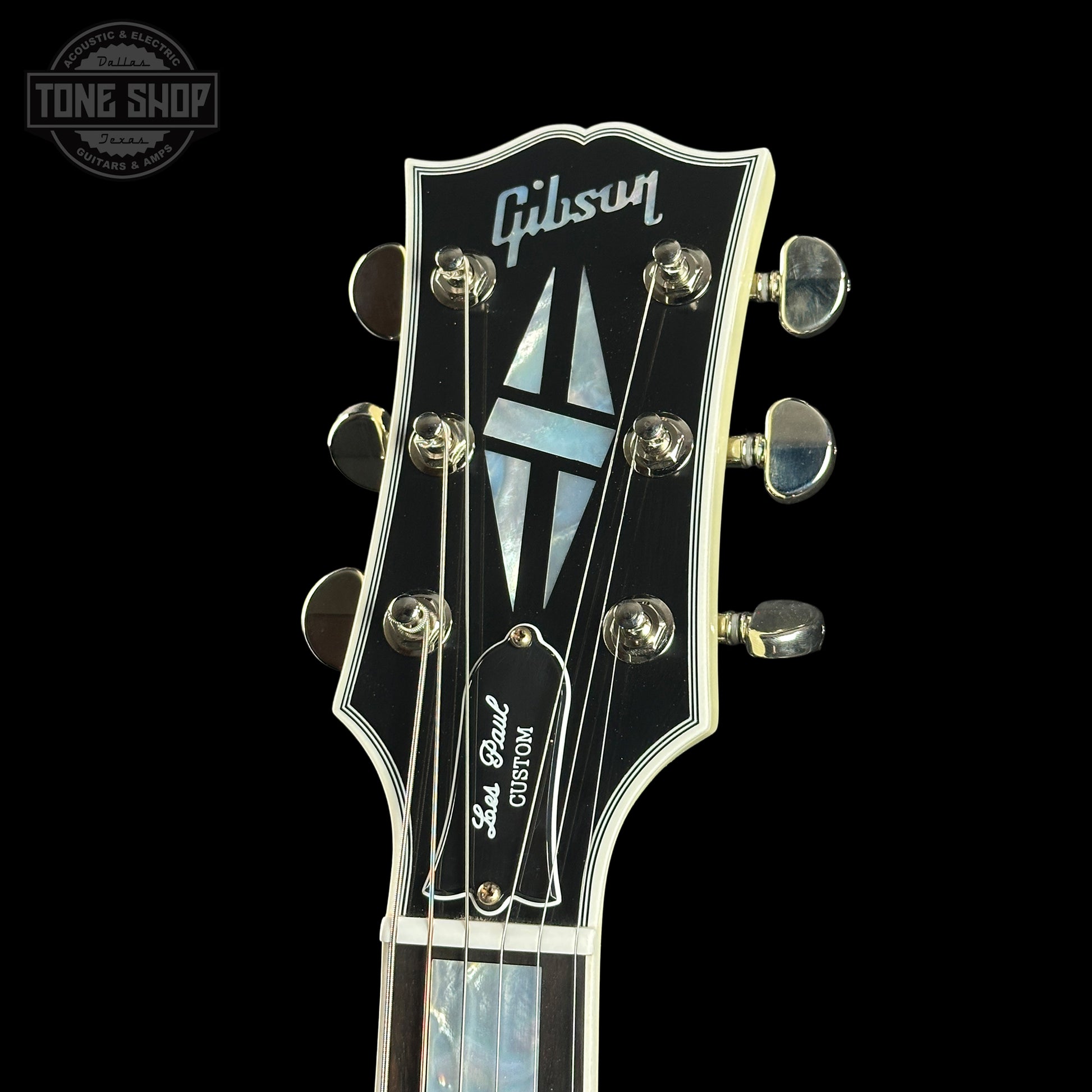 Gibson guitar headstock with brand logo on a black background