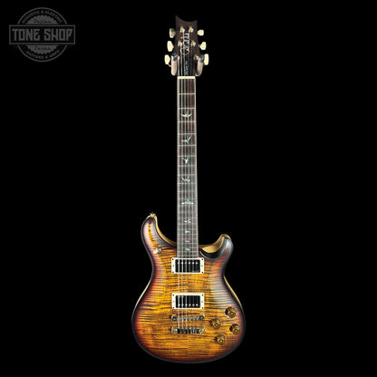 Electric guitar with a wood finish on a black background, featuring the Tone Shop logo.
