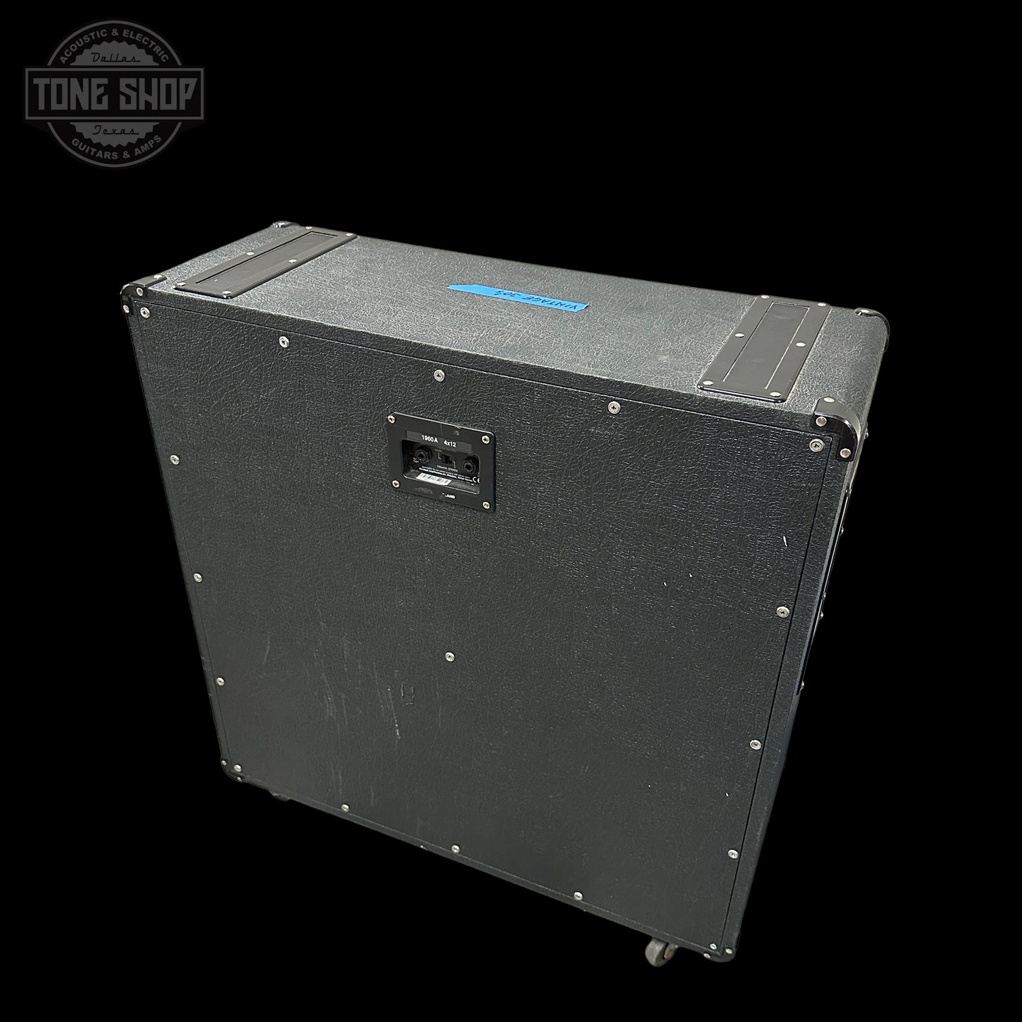 Black speaker cabinet with visible branding on a black background